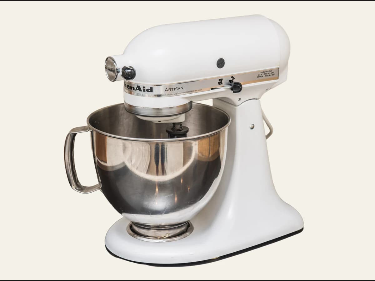 White KitchenAid Artisan stand mixer on a clean neutral listing background